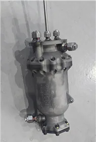 Vertical metal test article with pipe fittings attached for pressure testing.