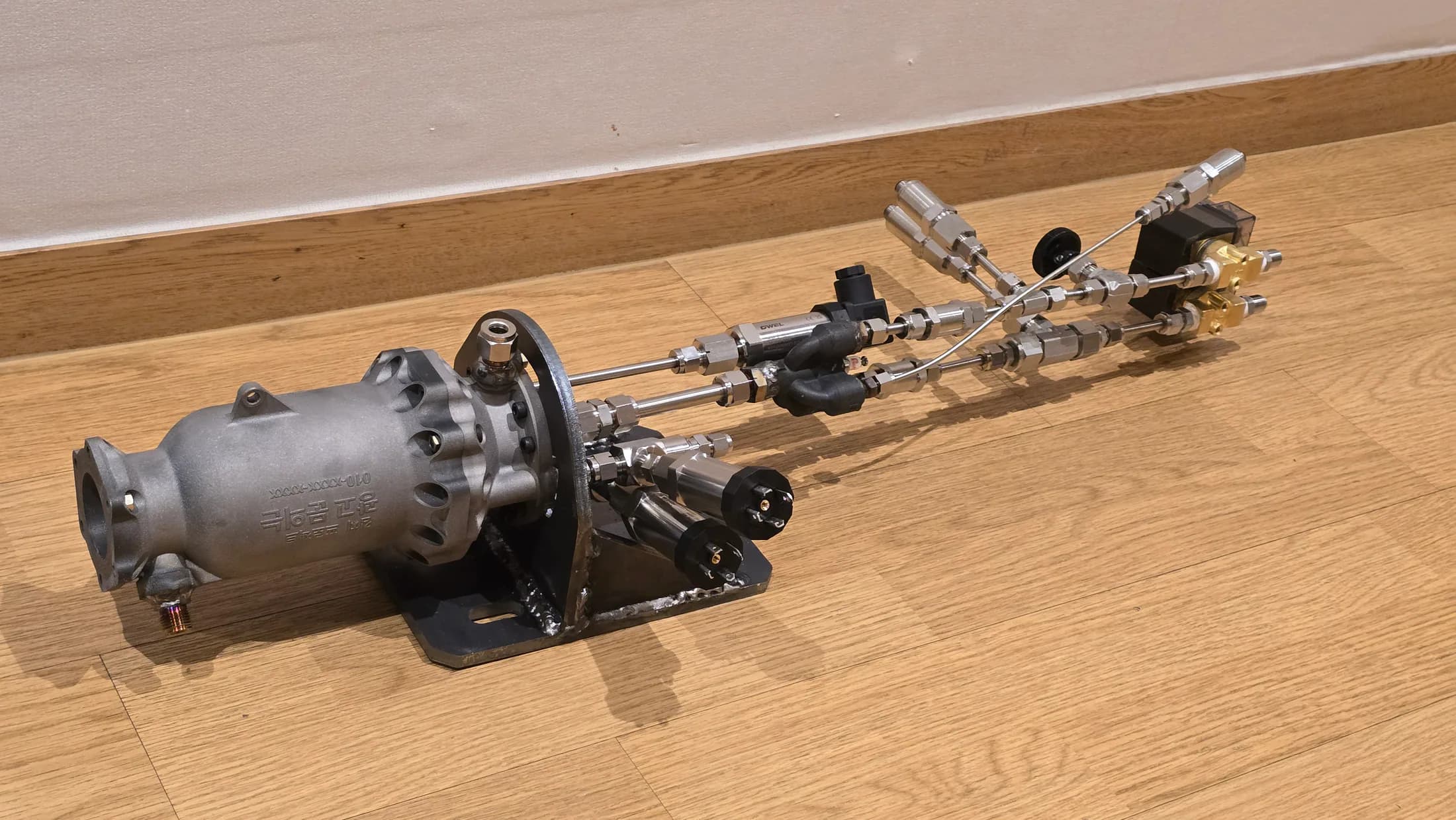Compact engine-side assembly laid out indoors after fabrication.