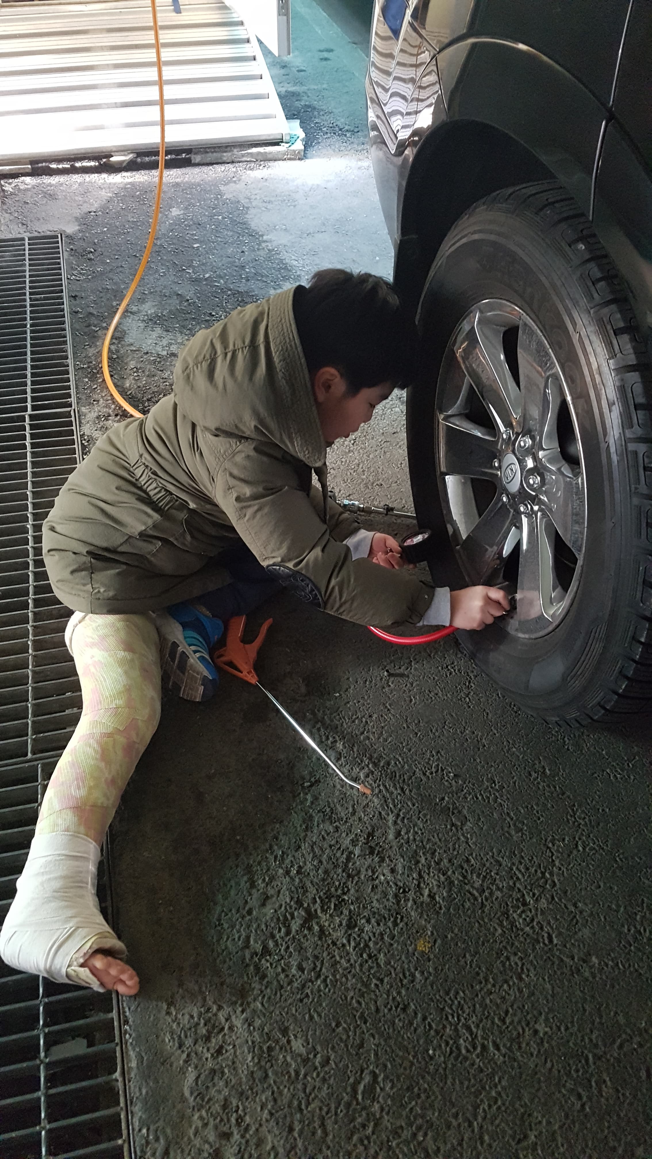 Early photo showing practical car maintenance exposure.