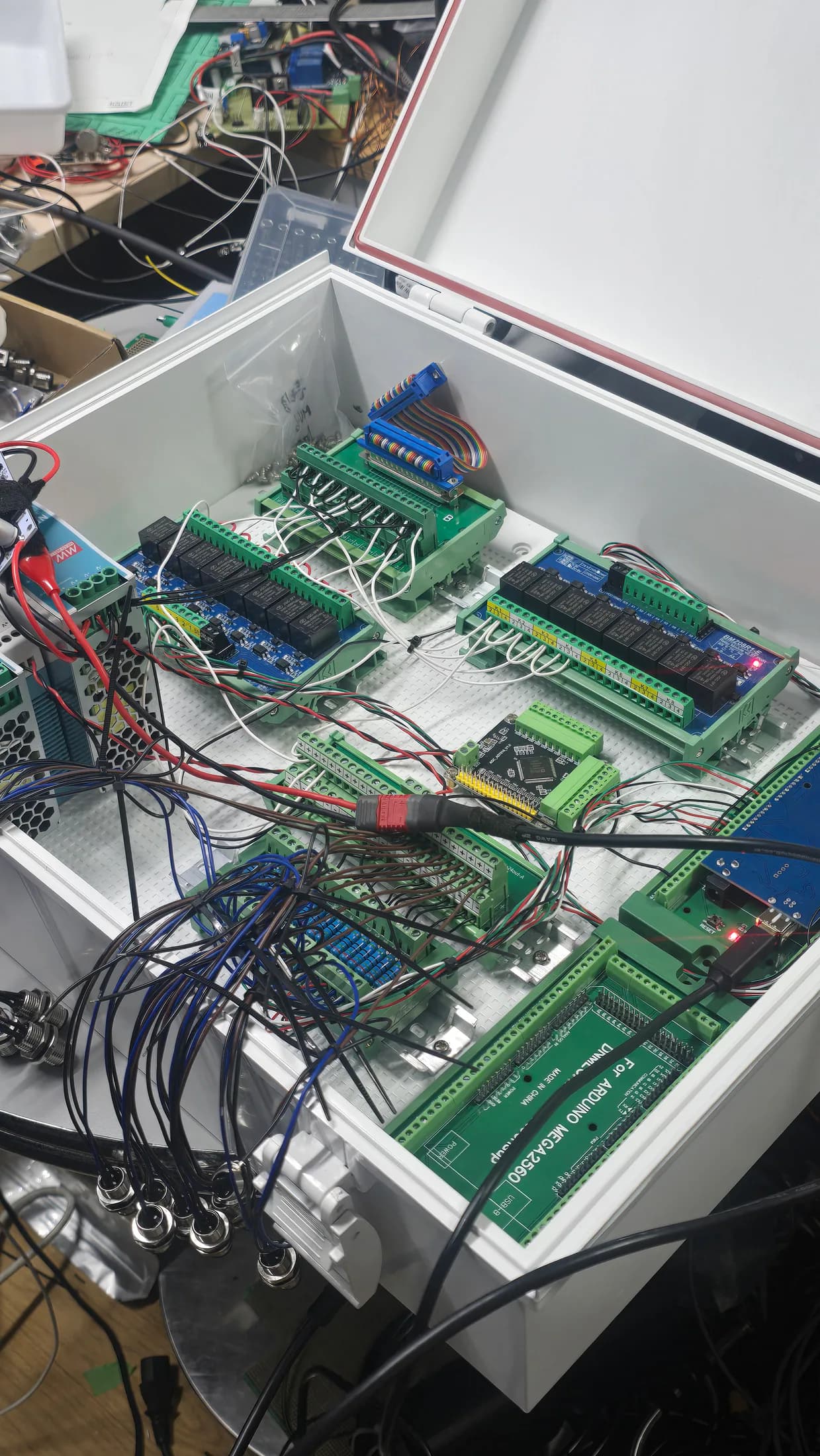 Open controller box showing circuit boards, connectors, and bundled cables.